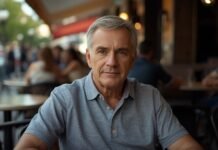 Why You May Pull Back Socially Without Realizing It After 50 Confident mature man enjoying coffee at outdoor cafe, embracing graceful aging, 50+ lifestyle.